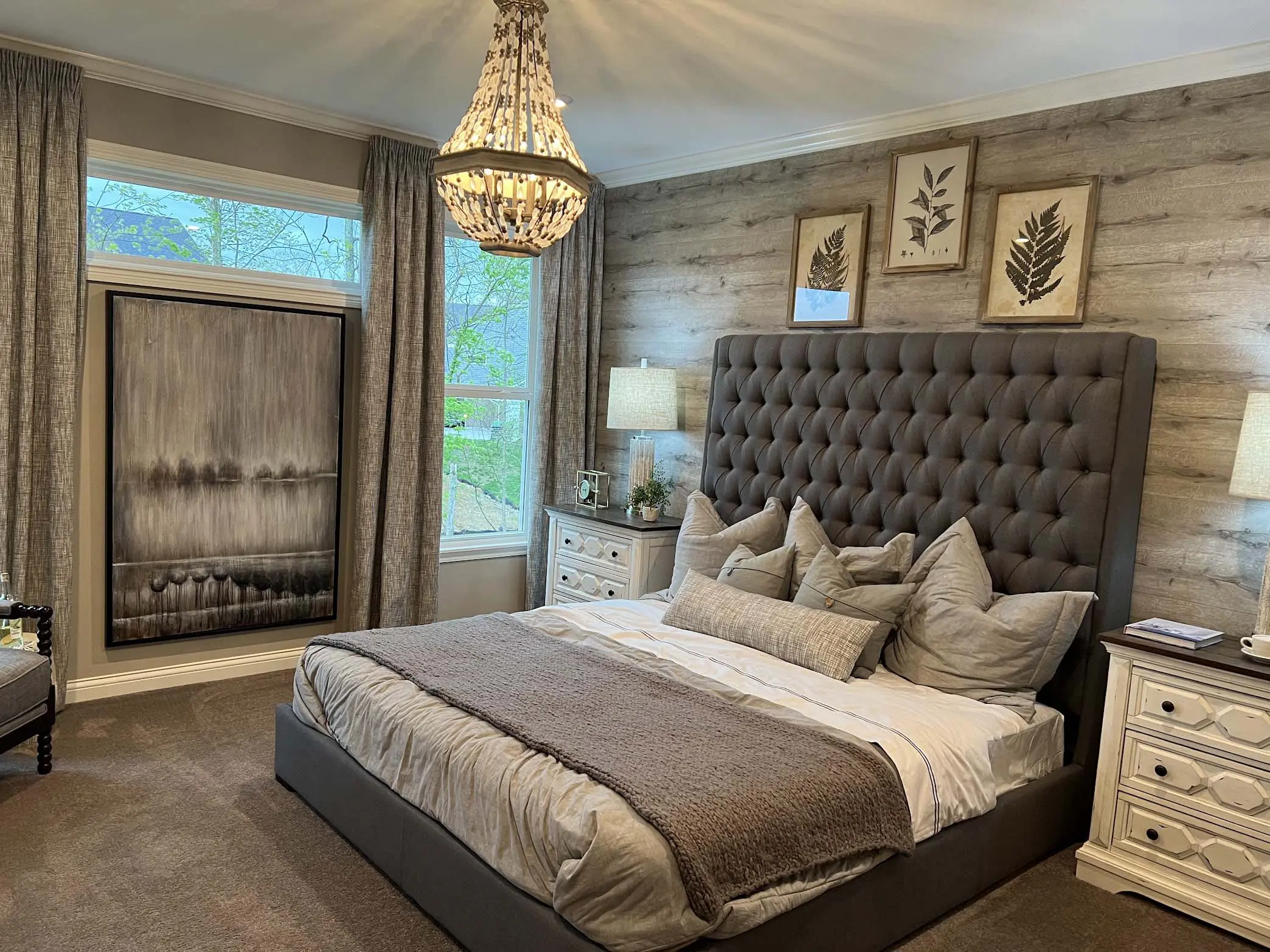 Tufted bed with chandelier in rustic bedroom