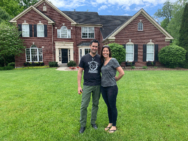 Yesso couple outside home with lawn