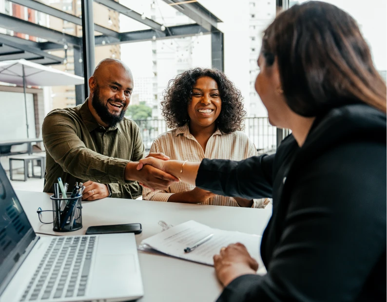 Smiling couple meeting with advisor