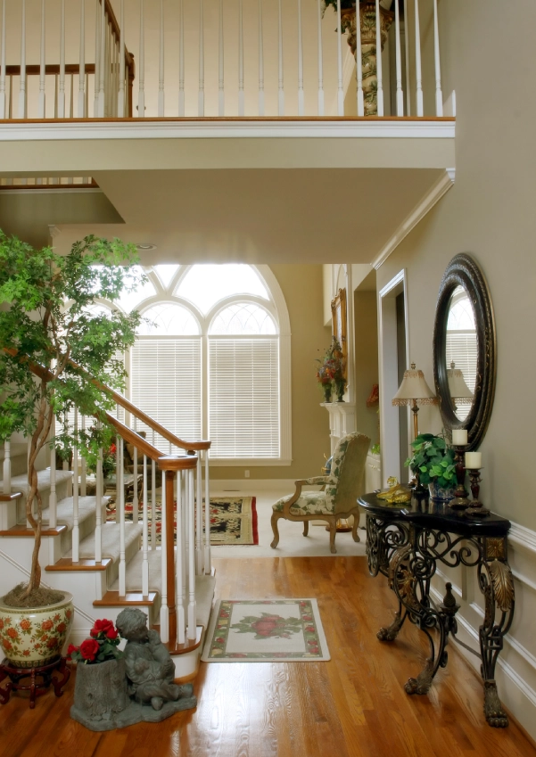 Home entryway featuring hardwood floors and railing