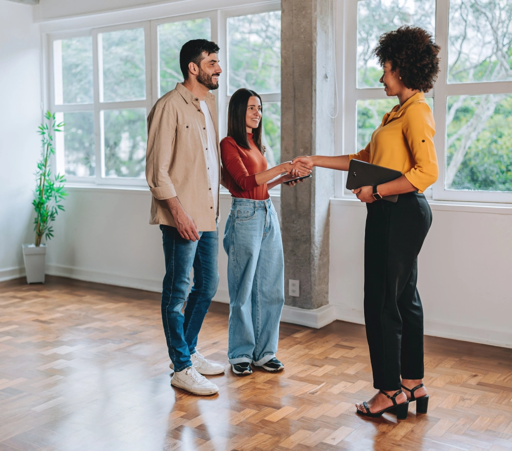 Homebuyers shaking hands with realtor