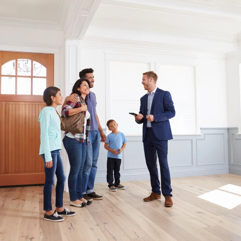 Family touring new home with real estate agent