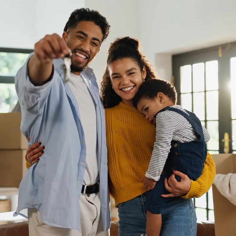 Parents and child with house keys
