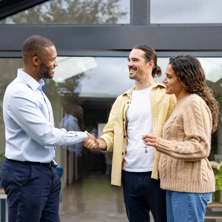 Group greeting in front of glass doors